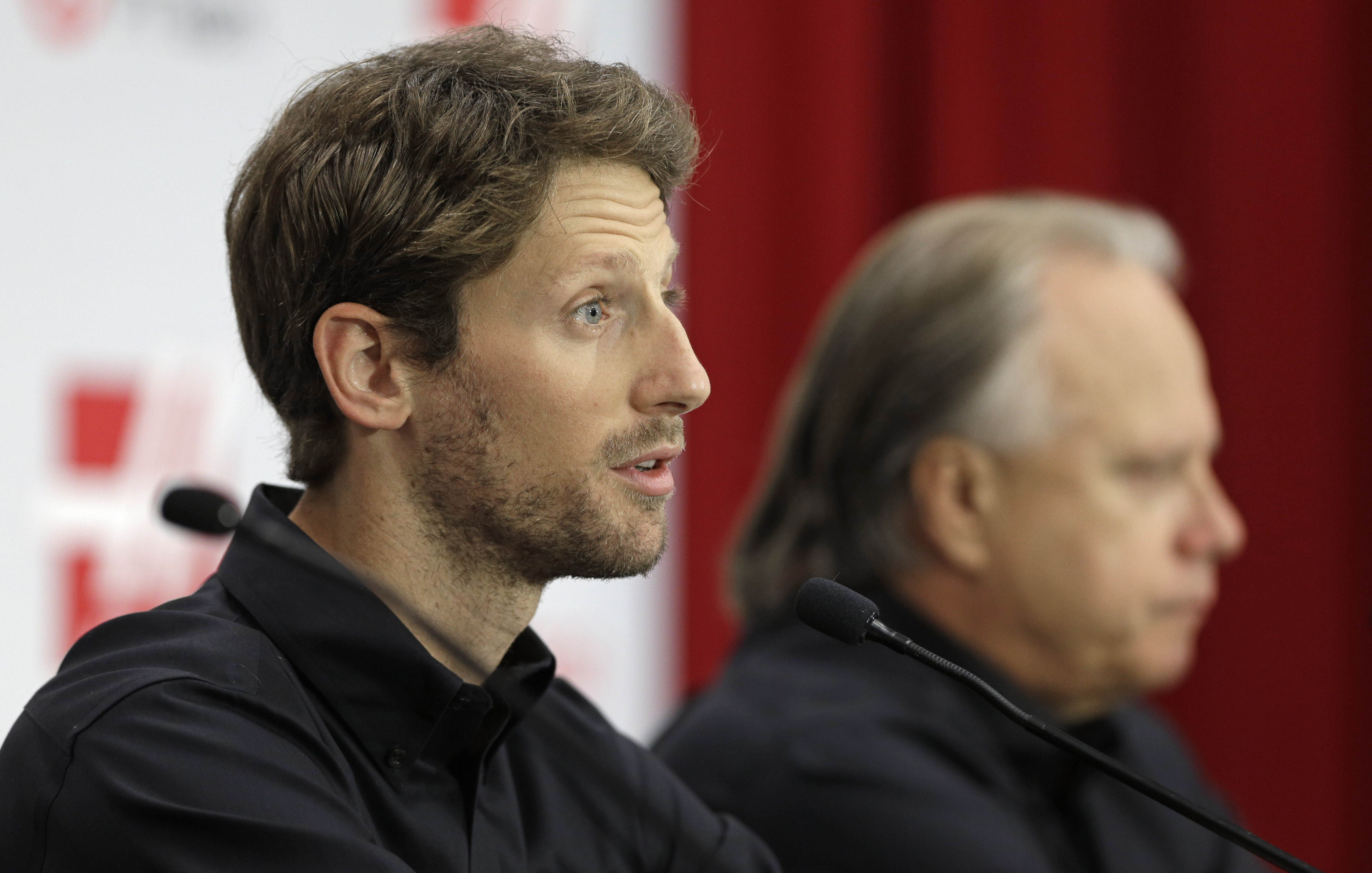 Driver Romain Grosjean, left, answers a question as team owner Gene Haas, right, listens during a news conference for Haas Racing's Formula One auto race team in Kannapolis, N.C., Tuesday, Sept. 29, 2015. (AP Photo/Chuck Burton)